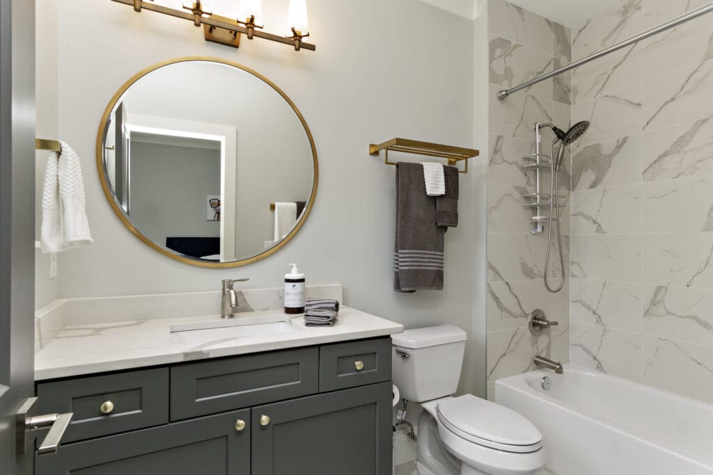 This images shows a modern bathroom with all new white paint and new marble tiles. affordable bathroom décor