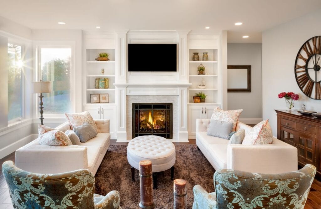 Beautiful living room with white couches and fireplace