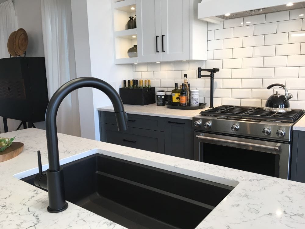 modern black kitchen sink with colored cabinet